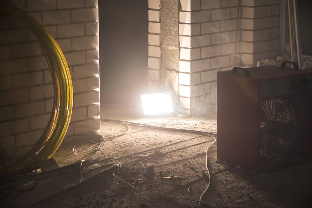 A work light shines on a building site.