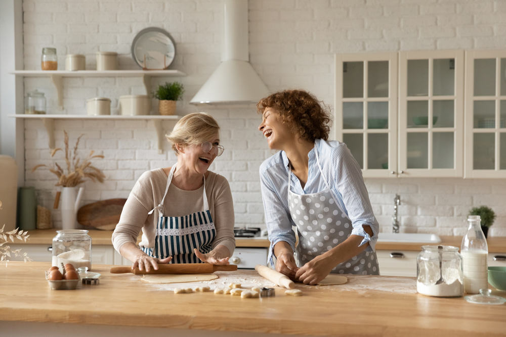 Two friends have a great time cooking in the kitchen.