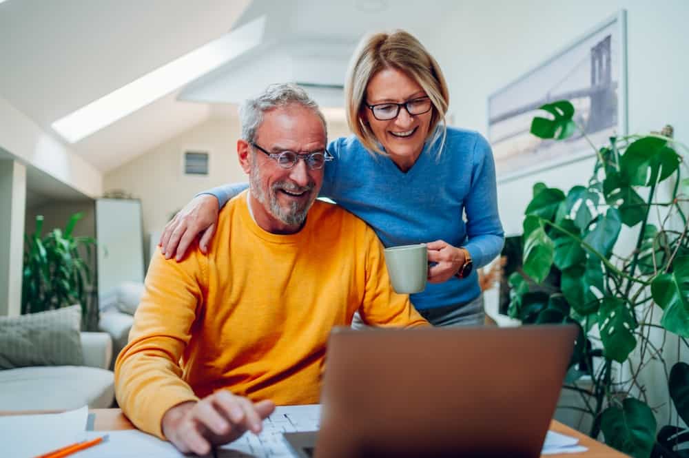 A happy couple reads good news together.