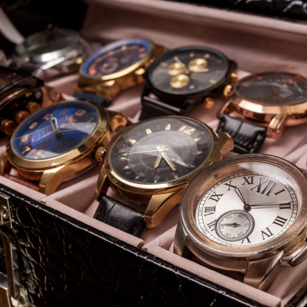 A collecting of fine watches sits in a display box.