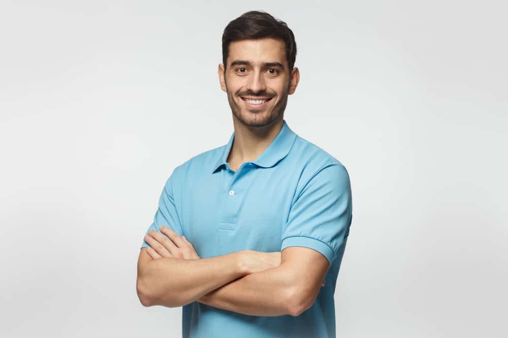 A man models a new blue polo shirt.