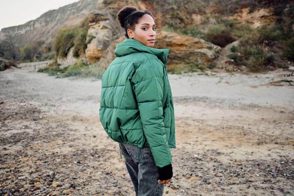 A woman models a stylish jacket outdoors.