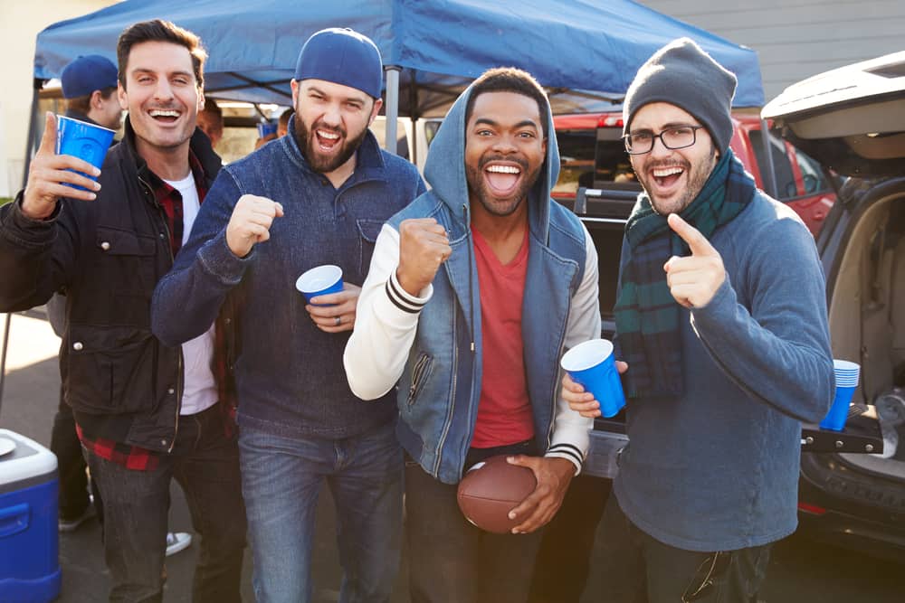 Four friends attend a football tailgate party.